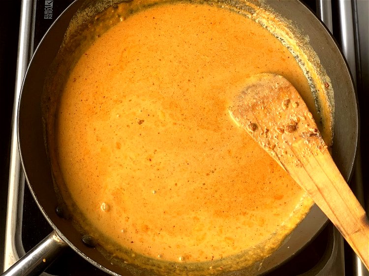 Image of Cook the curryWhisk the coconut milk mixture to ensure there...